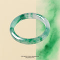 Bangle: translucent white jadeite with mossy green patches