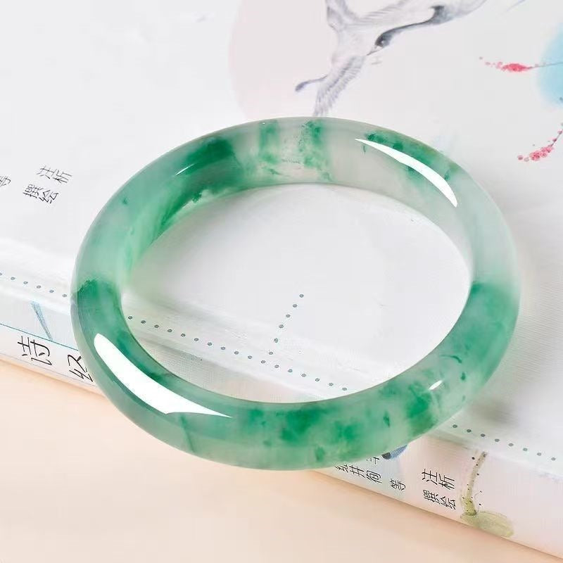 Bangle: translucent white jadeite with mossy green patches, second view