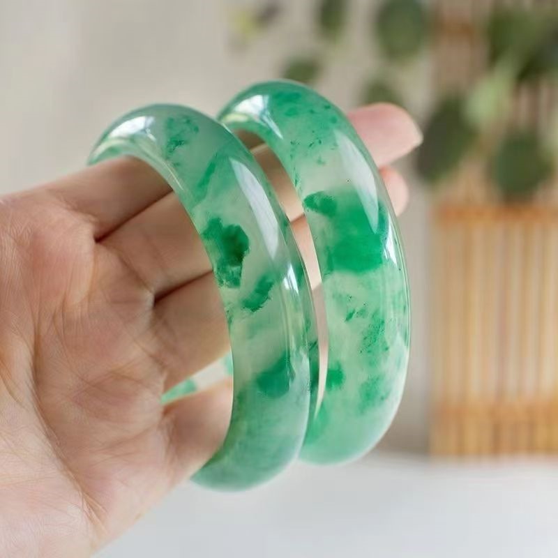 Bangle: translucent white jadeite with mossy green patches, third view