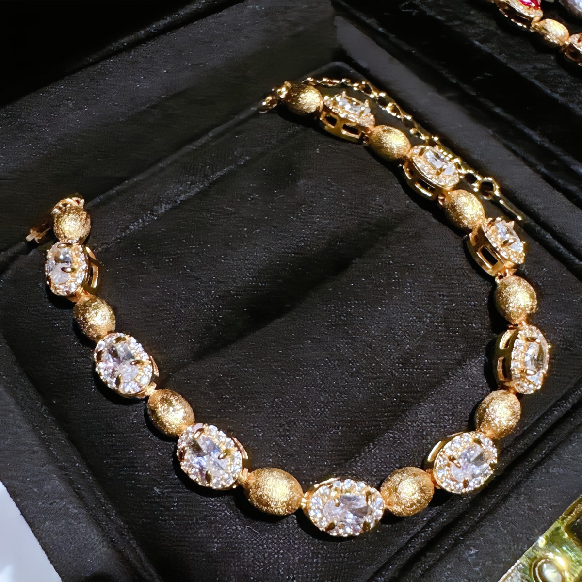 Bracelet: 18K gold plated brushed oval beads with clear cubic zirconia, second view