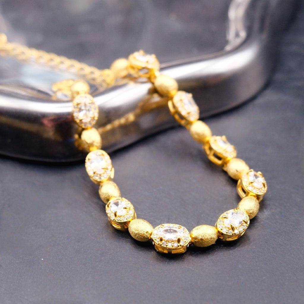 Bracelet: 18K gold plated brushed oval beads with clear cubic zirconia, fourth view