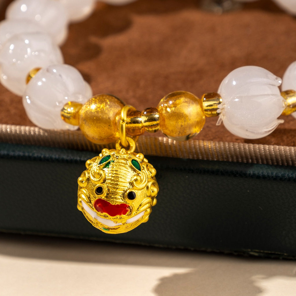 Bracelet: translucent pale white lotus-shaped liuli glass beads with a charm, fourth view