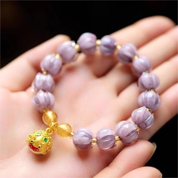 Bracelet: dusky lavender lotus-shaped liuli glass beads with a Tunjin beast charm, third view