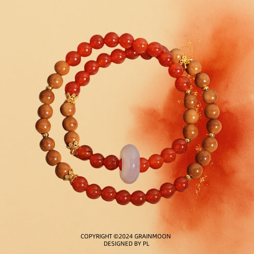 Bracelet: two strands of red agate beads and brown wood beads with a frosted white ring