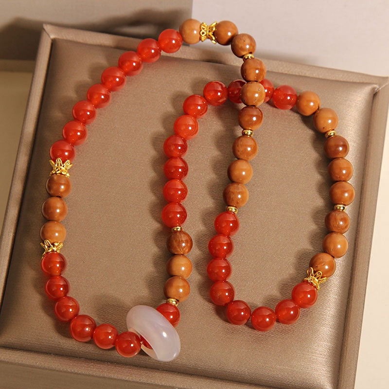 Bracelet: two strands of red agate beads and brown wood beads with a white ring, second view