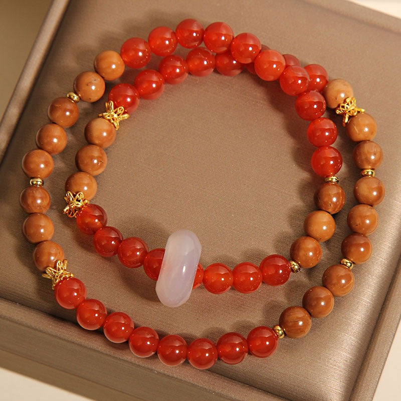 Bracelet: two strands of red agate beads and brown wood beads with a white ring, third view