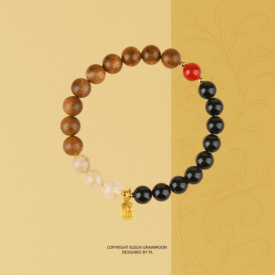 Bracelet: brown agarwood beads, black agate beads and pale quartz beads with one red bead and a gold charm