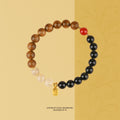 Bracelet: brown agarwood beads, black agate beads and pale quartz beads with one red bead and a gold charm