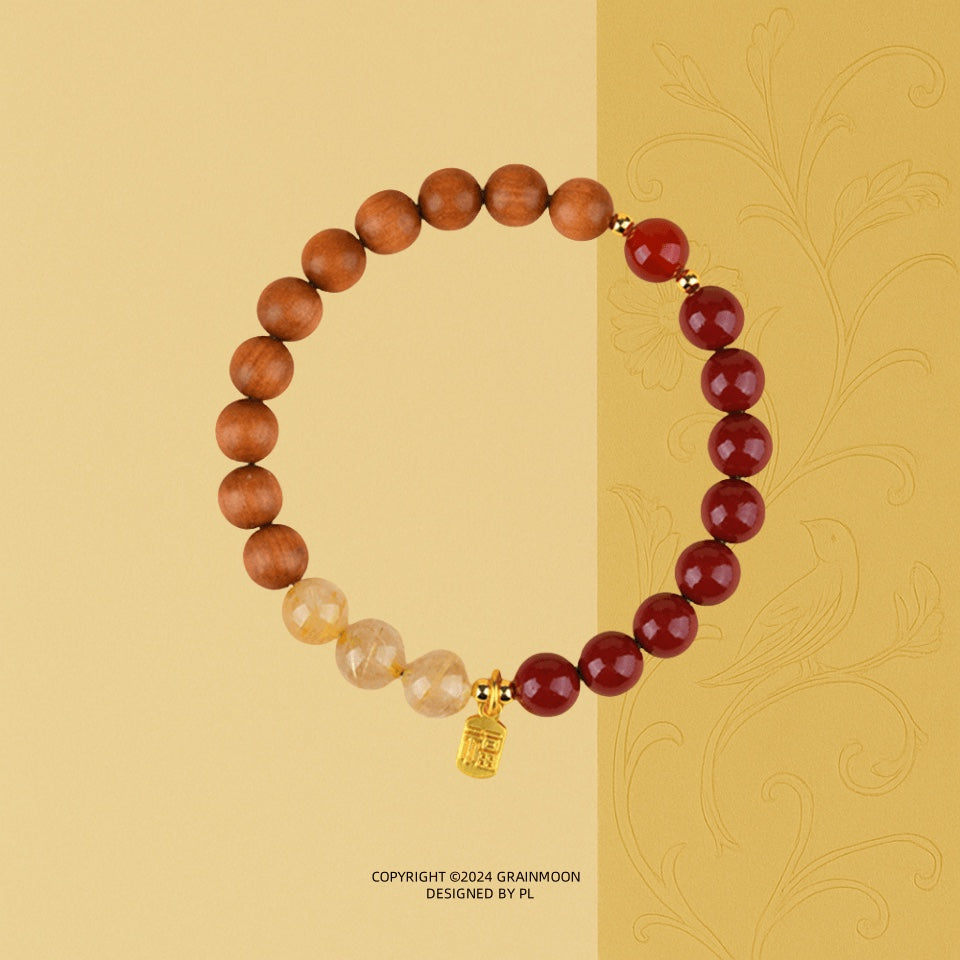 Bracelet: brown sandalwood beads, dark red agate beads and pale golden quartz beads with a gold charm