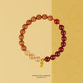 Bracelet: brown sandalwood beads, dark red agate beads and pale golden quartz beads with a gold charm