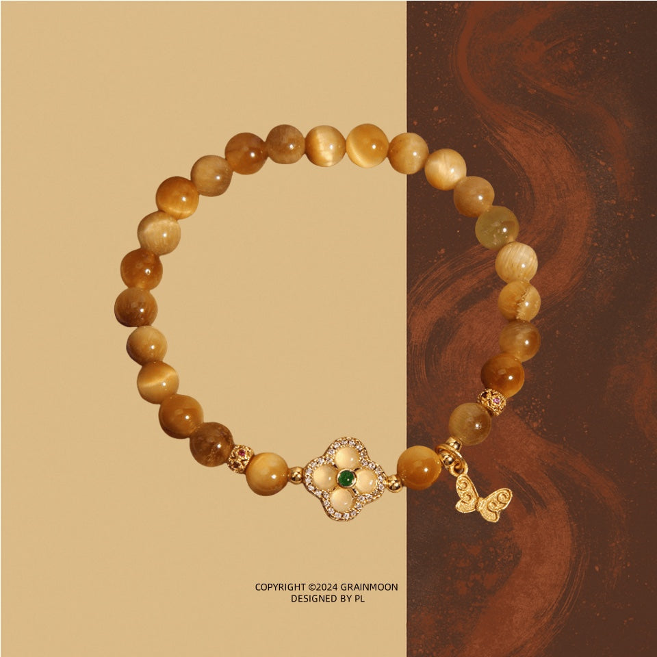 Bracelet: golden tiger's eye beads with a gold-tone four-leaf clover clasp and a small butterfly charm