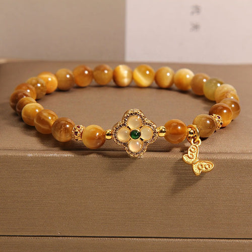 Bracelet: golden tiger's eye beads with a gold-tone four-leaf clover clasp, second view