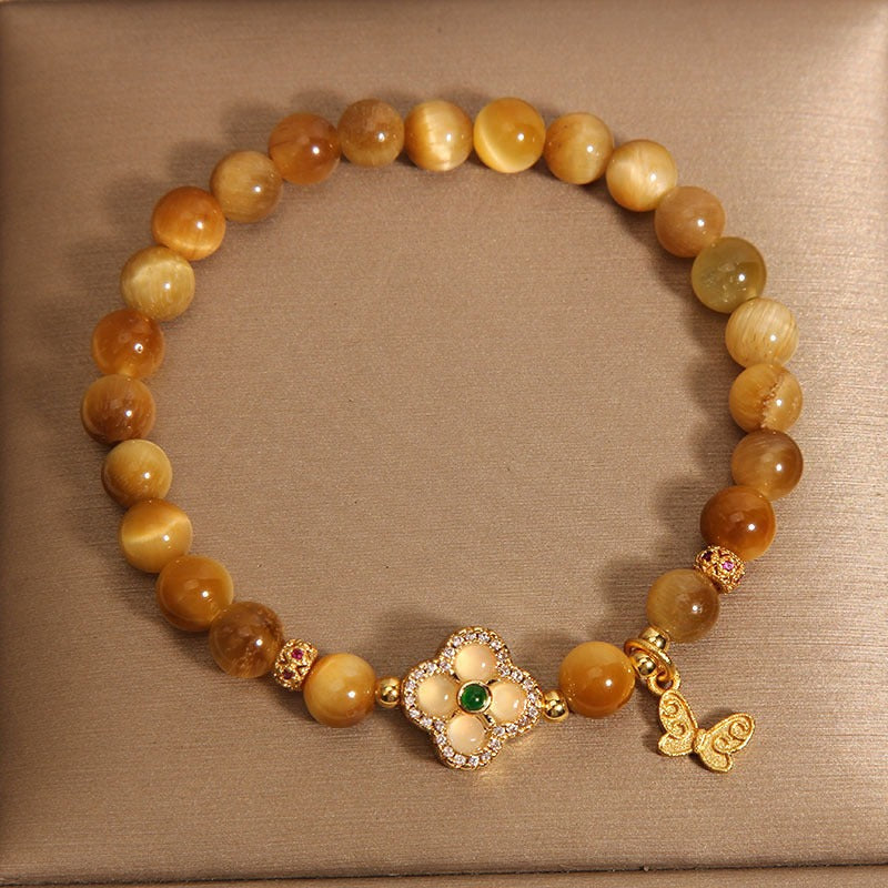 Bracelet: golden tiger's eye beads with a gold-tone four-leaf clover clasp, third view