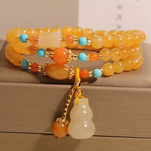 Bracelet: multi-wrap golden-yellow lab-created jade beads with a gourd charm, second view