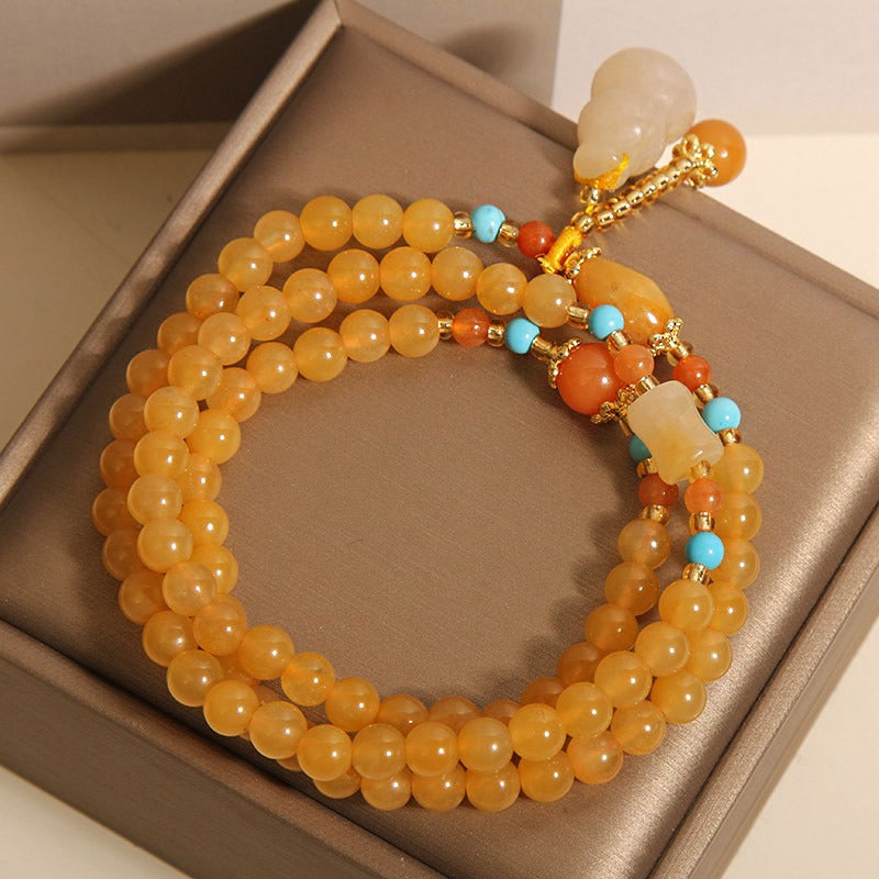 Bracelet: multi-wrap golden-yellow lab-created jade beads with a gourd charm, third view