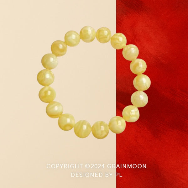 Bracelet: round pale yellow marbled amber beads