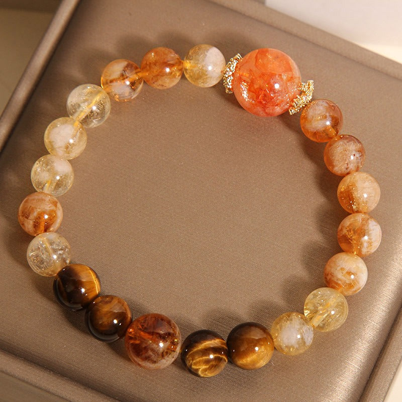 Bracelet: golden rutilated quartz beads, cat's eye beads and an orange-red centre bead, second view