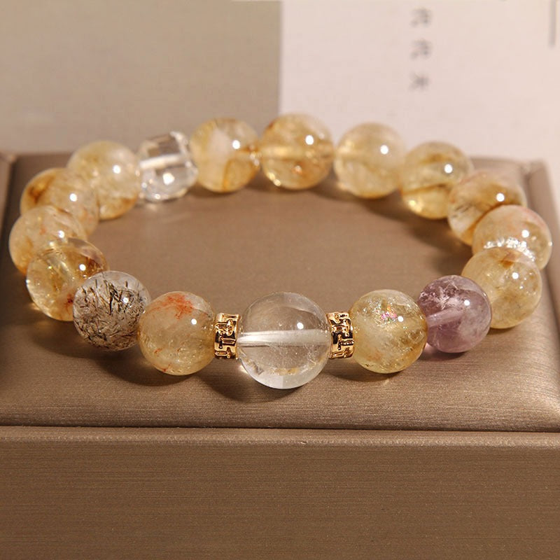 Bracelet: golden rutilated quartz beads with a faceted white quartz cube