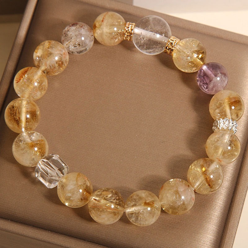 Bracelet: golden rutilated quartz beads with a faceted white quartz cube, second view