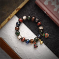 Bracelet: dark liuli glass beads in red, blue, green, white and brown with three small round charms
