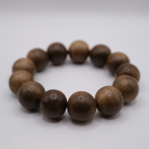 Bracelet: large dark brown Kalimantan agarwood beads with visible grain, third view