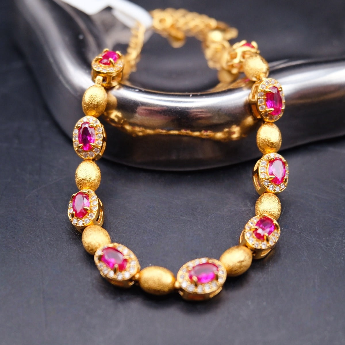 Bracelet: 18K gold plated oval beads with lab-created ruby stones in halos, third view