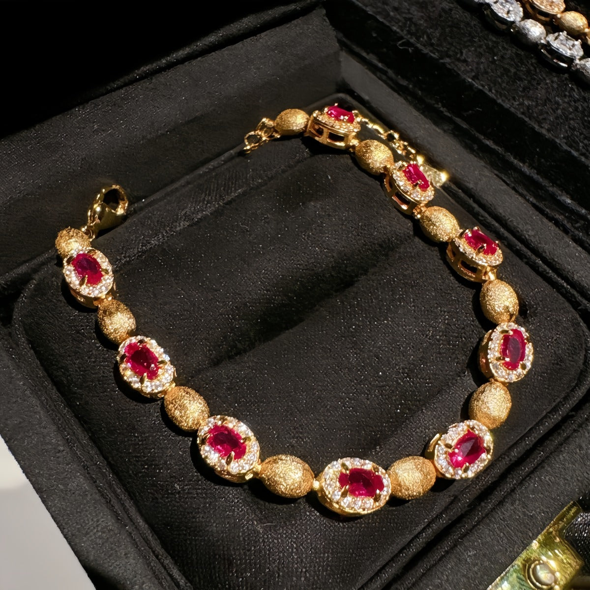 Bracelet: 18K gold plated oval beads with lab-created ruby stones in halos, fifth view