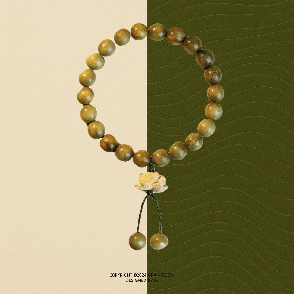 Bracelet: olive-brown green sandalwood beads with a carved boxwood lotus charm and two bead tassels