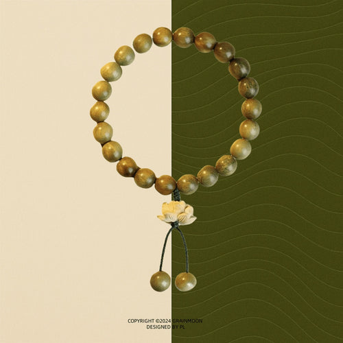 Bracelet: olive-brown green sandalwood beads with a carved boxwood lotus charm and two bead tassels