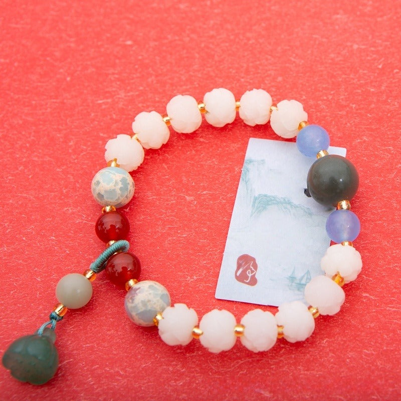 Bracelet: white lotus-petal bodhi root beads with blue, green and red accents, second view