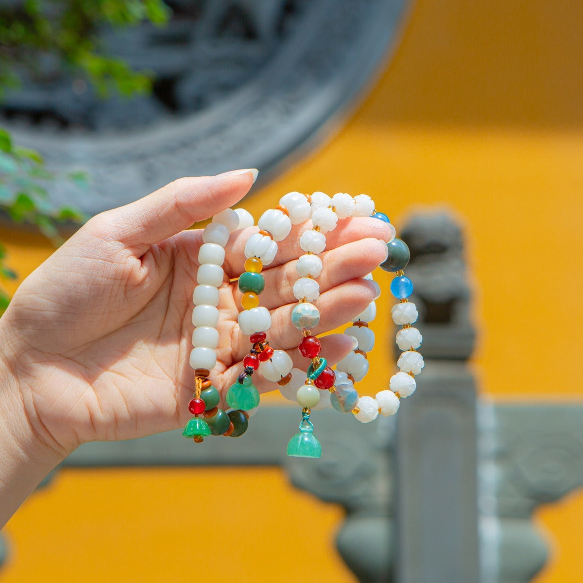 Bracelet: white lotus-petal bodhi root beads with blue, green and red accents, third view