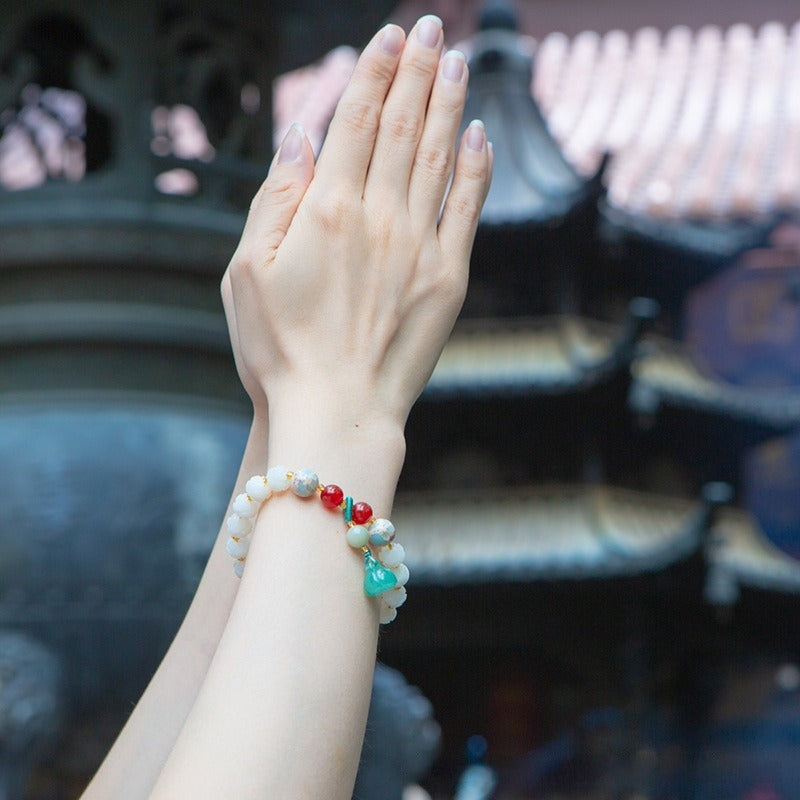 Bracelet: white lotus-petal bodhi root beads with blue, green and red accents, fourth view