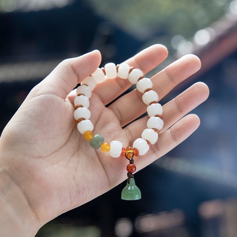 Bracelet: white pumpkin-shaped bodhi root beads with yellow, green and red accents, second view