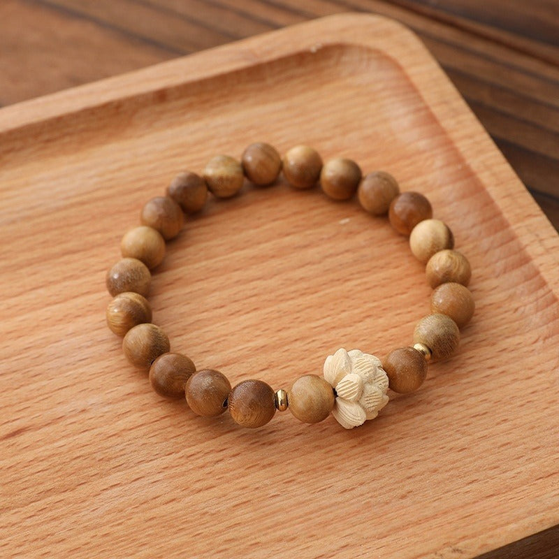 Bracelet: light brown green sandalwood beads with a cream boxwood lotus bead, second view