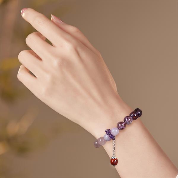 Bracelet: violet amethyst beads, 10mm, with rose quartz and a red agate bead, third view