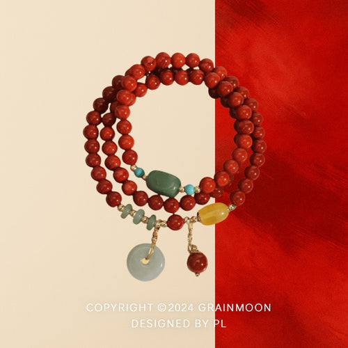 Bracelet: multi-wrap strand of red agate beads with green and yellow accent stones and a pale jadeite circle pendant