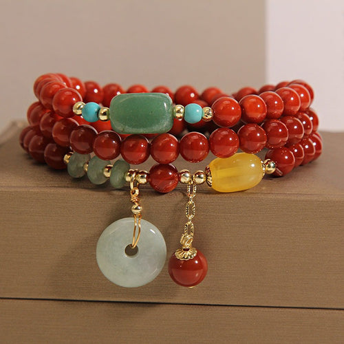 Bracelet: multi-wrap red agate beads with a pale jadeite circle pendant, second view