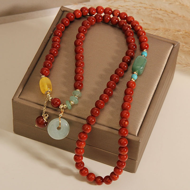 Bracelet: multi-wrap red agate beads with a pale jadeite circle pendant, fourth view