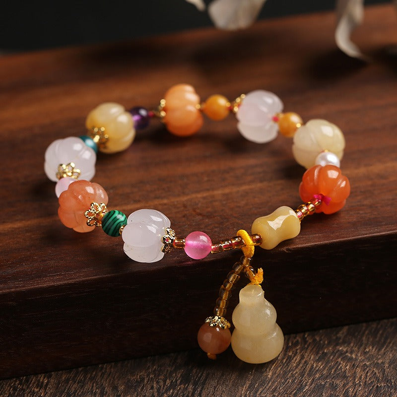 Bracelet: pumpkin-shaped carved lab-created yellow jade beads in cream, pink and orange with a cream gourd charm