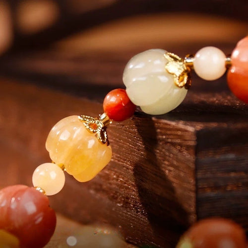 Bracelet: pumpkin-shaped lab-created yellow jade beads in cream, pink and orange, second view