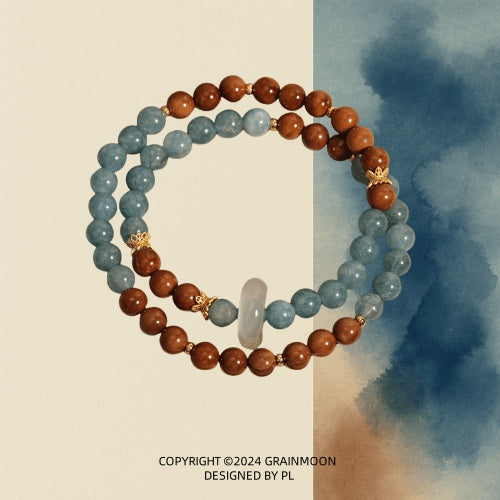 Bracelet: two strands, blue-green amazonite beads and brown wood beads, joined by a pale chalcedony ring