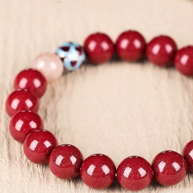 Bracelet: round deep crimson cinnabar beads with a lotus-shaped bead, second view