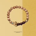 Bracelet: light brown Ya Bai cypress beads with dark red-brown accent beads and a golden ring bead