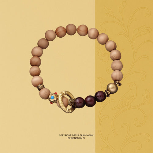 Bracelet: light brown Ya Bai cypress beads with dark red-brown accent beads and a golden ring bead