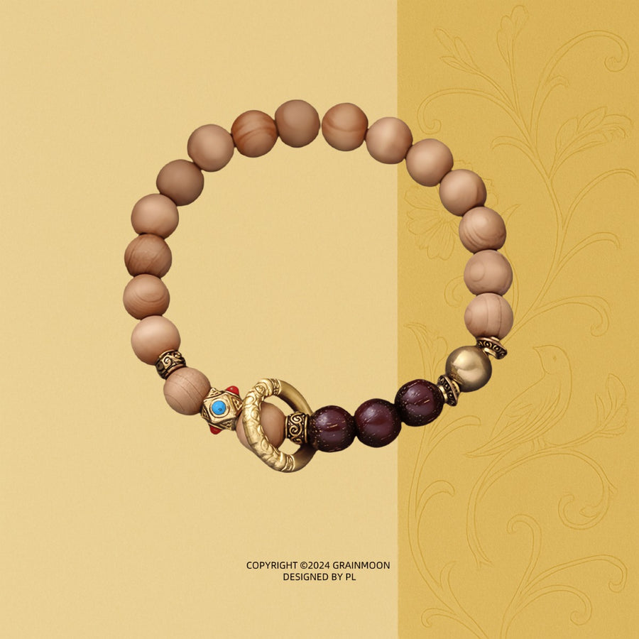 Bracelet: light brown Ya Bai cypress beads with dark red-brown accent beads and a golden ring bead