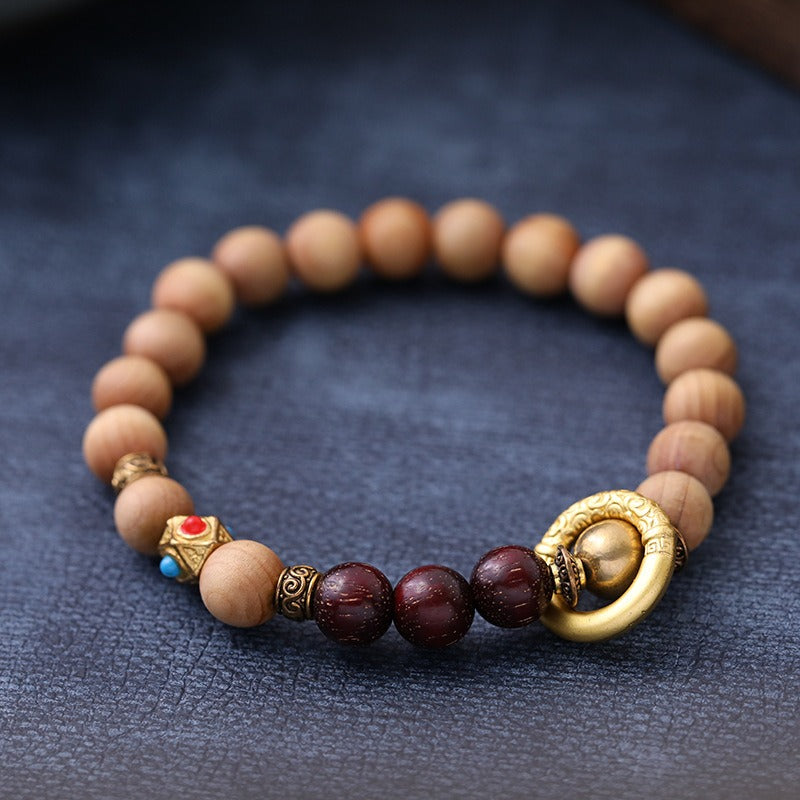 Bracelet: light brown Ya Bai cypress beads with dark red-brown accent beads, third view