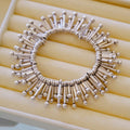 Bracelet: sculptural polished 925 sterling silver bracelet of radiating tubes with ball ends, on a cream tray