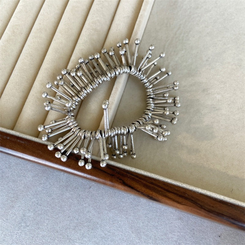 Bracelet: sculptural polished design of radiating tubes with ball ends, second view