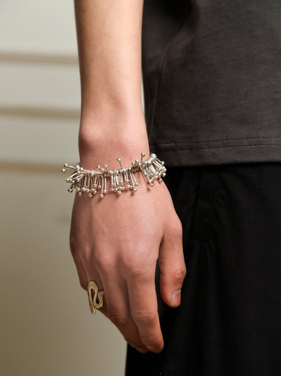 Bracelet: sculptural polished design of radiating tubes with ball ends, fifth view