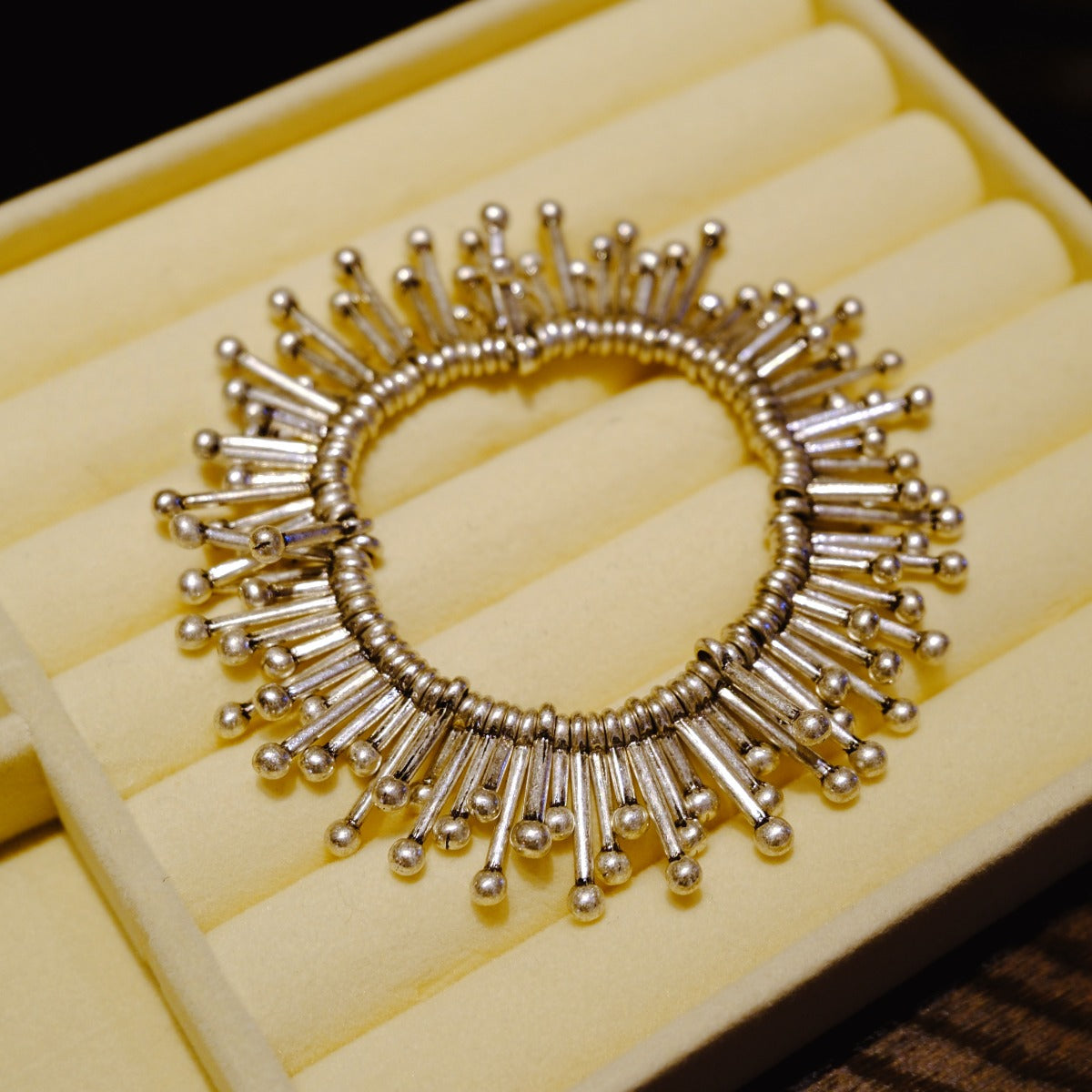 Bracelet: sculptural polished design of radiating tubes with ball ends, seventh view